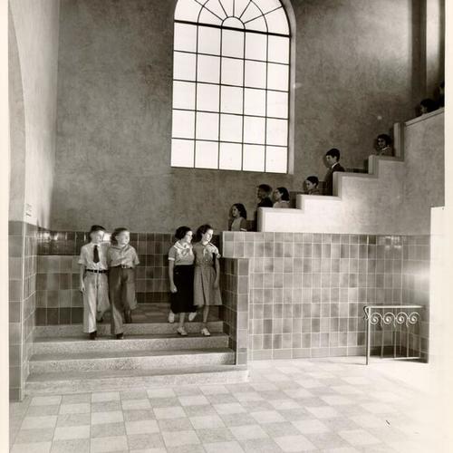 [Students walking down a stairway at the entrance to the Health Division of Sunshine Orthopedic School]