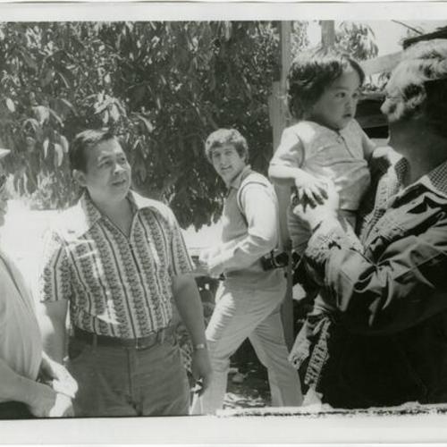 [George Moscone holding a child at the Gran Oriente Filipino Masonic picnic in South Park]