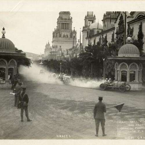[Race cars driven by Hughie Hughes and Harry Grant rounding a corner during the Vanderbilt Cup Race at the Panama-Pacific International Exposition]
