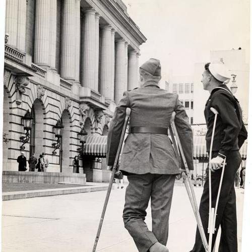 [Soldier Robert S. Norris and Sailor Thomas J. Kyle standing outside of the War Memorial Veterans Building]