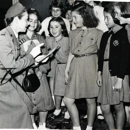 [Mrs. Clyde J. Schoenfeld, San Francisco chairman of the Girl Scout cookie sale, training girls on salesmanship]