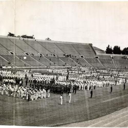 [Columns of uniformed people standing at attention on the field at Kezar Stadium]