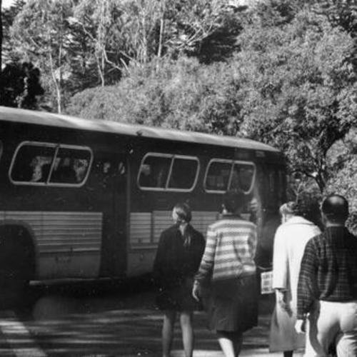 [People boarding a MUNI bus in Golden Gate Park]