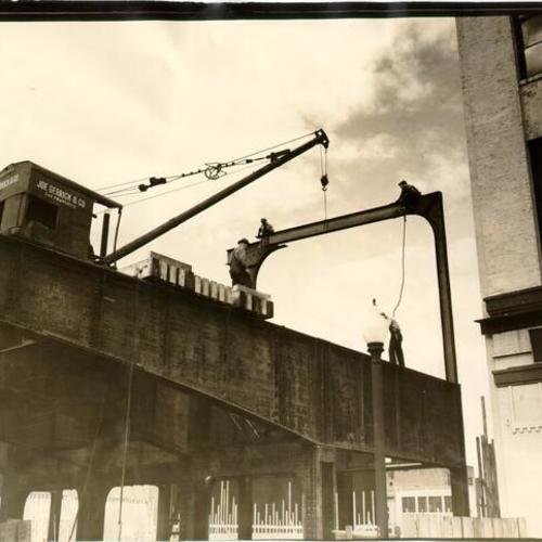 [First steel for the roof of the Terminal Building for the San Francisco-Oakland Bay Bridge being set in place]
