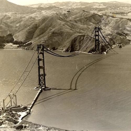 [Aerial view of Golden Gate Bridge under construction]