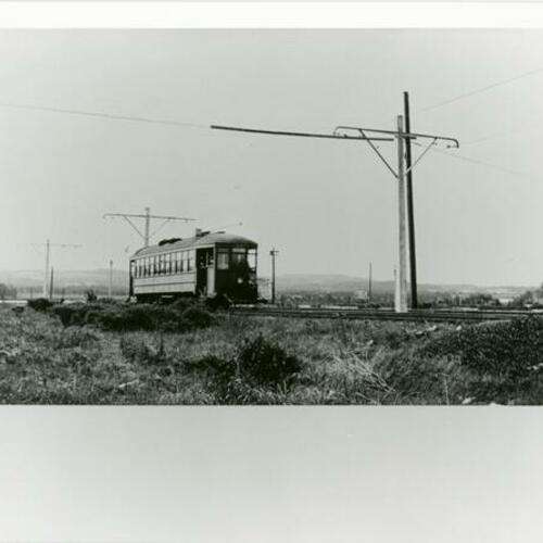 [Muni car and M Line northbound on right of way just north of 21st Avenue and Eucalyptus Drive]