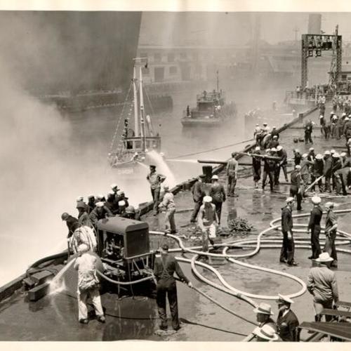 [Coast Guard crew fighting a fire at the San Francisco waterfront]