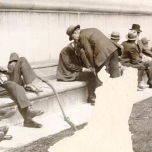 [Men sitting at the exterior of Main Library in 1930's]