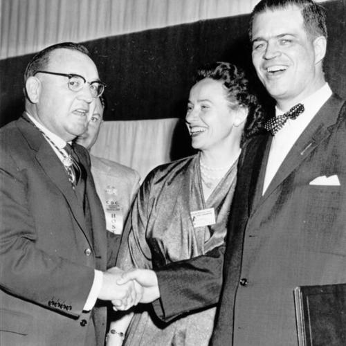 [Attorney General Edmund G. (Pat) Brown (center), seeking Democratic nod for governor, greets Gov. G. Mennen Williams, Mich., at California Democratic Council meeting]
