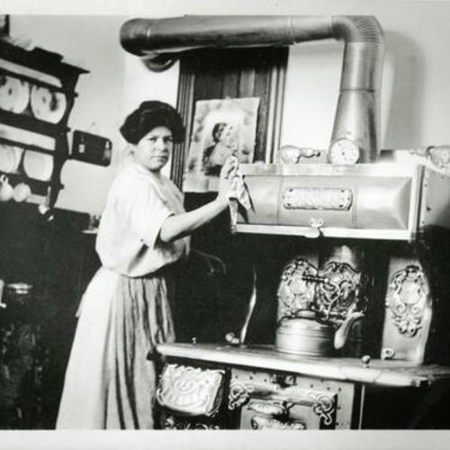 [Portrait of a woman standing in her kitchen and Peninsular Stove on Valley Street]