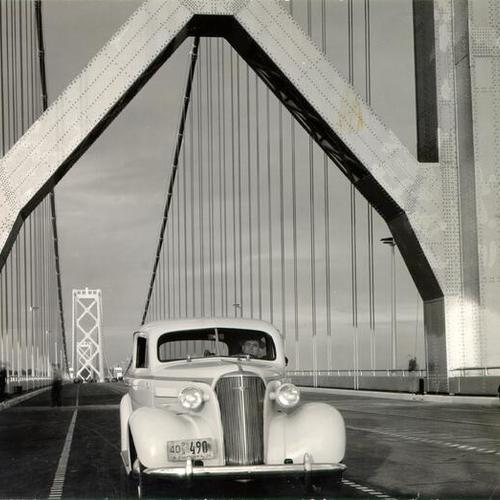[Unidentified man sitting behind the wheel of a car on the San Francisco-Oakland Bay Bridge]