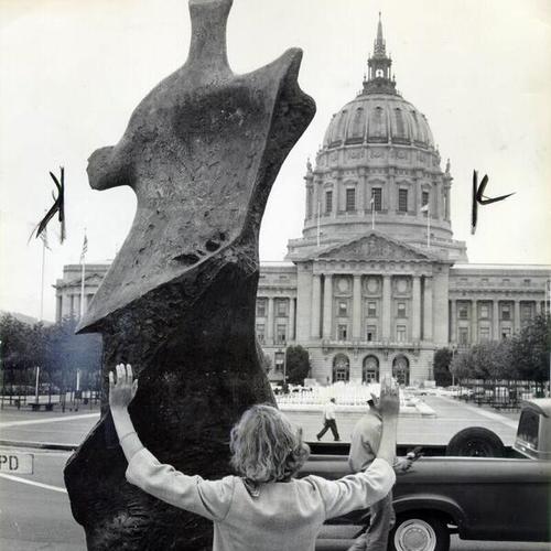 [Laurie MacTavish admiring 'Winged Figure' a sculpture by Henry Moore, Civic Center Plaza]