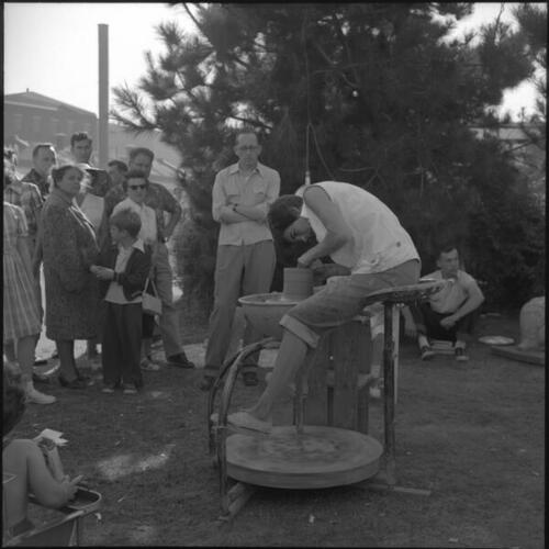 People watching person using pottery wheel at the San Francisco Arts Festival
