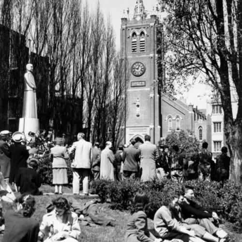 [People attending Good Friday services at Old St. Mary's Church gather across the street in St. Mary's Square]