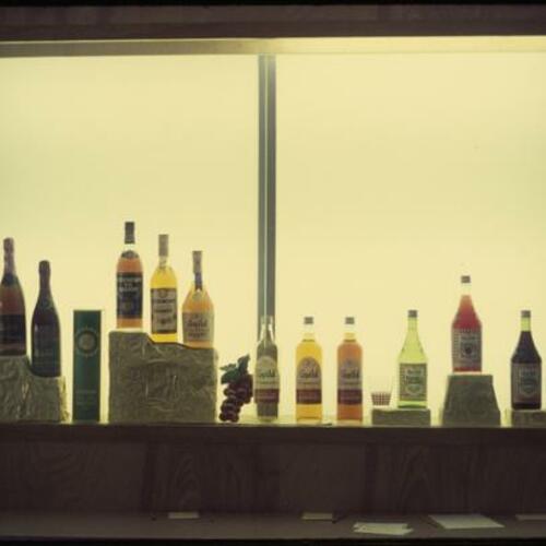 Alcohol bottles on display behind bar