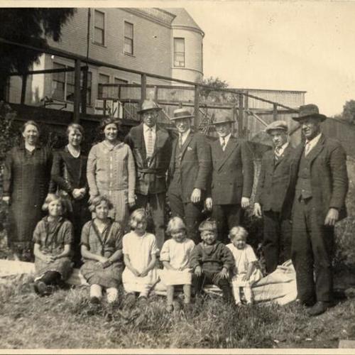 [Unidentified group of people gathering for a photograph in the Mission district]