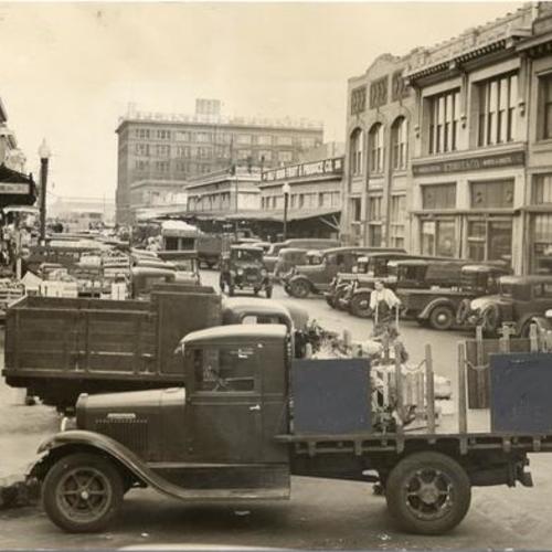 [Produce trucks being loaded in the Commission District]