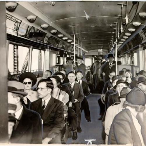 [Passengers on board the first electric train to cross the San Francisco-Oakland Bay Bridge]