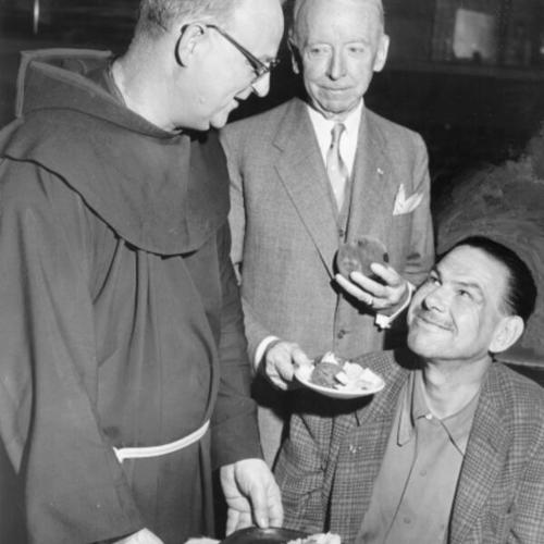 [Father Alfred Boeddeker serves the three millionth meal at St. Anthony's dining room]