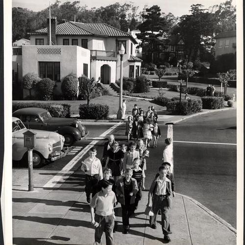 [School children crossing a street in the Forest Hill district]