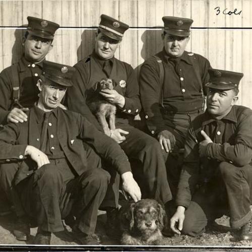 [Five firemen from old Engine 6 posing with two dogs]
