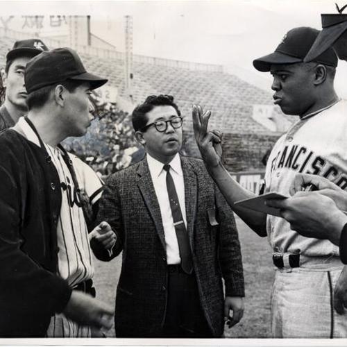 [Willie Mays talking to Japanese players during recent tour against the Japanese All-Stars in Japan]