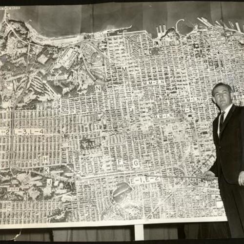 [Burch C. Bachtold standing before a map with the new freeway system]