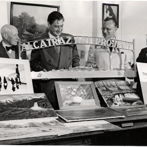 [Commissioners Paul Verdier, Joseph McCarthy, Ernest Born and Antonio Sotomayor looking over the work of Alcatraz convicts for the Open Air Art Show at Union Square]