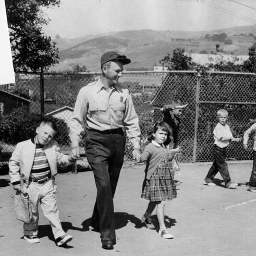 [Royer and youngsters from Angel Island walking into the Fort Baker schoolyard]