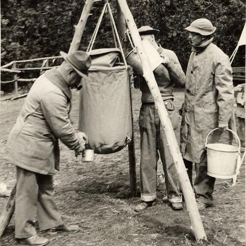 [CCC enrollees stationed at the Forestry Work Camp Wawoma Park in the camp portable drinking water system]
