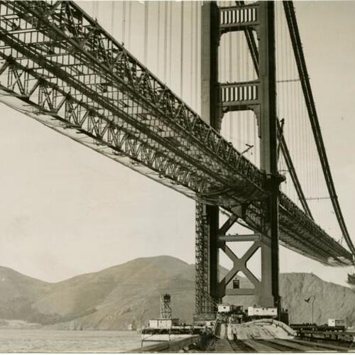 [View of the Golden Gate Bridge while under construction, showing safety net used to protect workers]