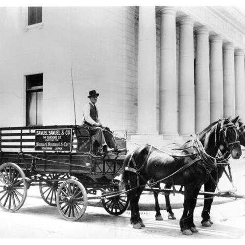 [Man sitting on a horse drawn wagon in front of the United States Treasury building]