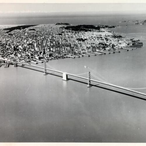 [Aerial view of the San Francisco-Oakland Bay Bridge, looking west with San Francisco and the Golden Gate Bridge in the background]