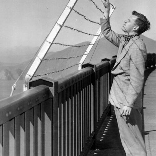 [George Murphy inspecting a test model of a proposed "suicide fence" for the Golden Gate Bridge]