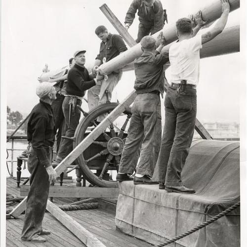 [Group of men working on the deck of the sailing ship "Pacific Queen" (also known as the "Balclutha")]
