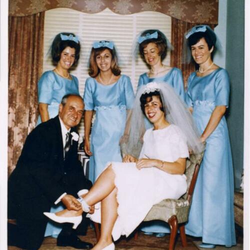 [Judy on her wedding day surrounded by her father, sister, cousin and friends]