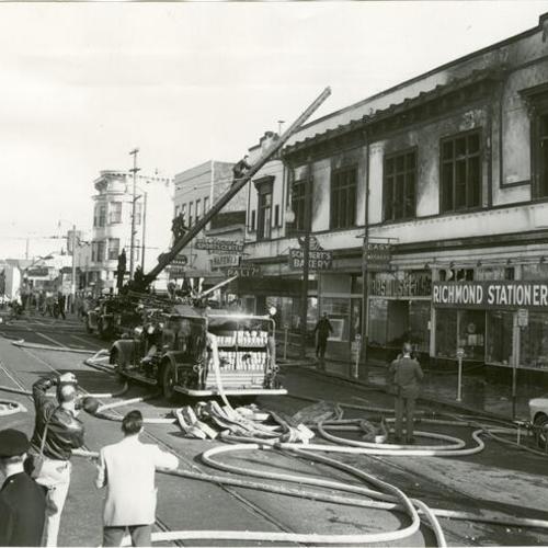 [Firemen cleaning up at scene of fire on Clement Street between 6th and 7th avenues]