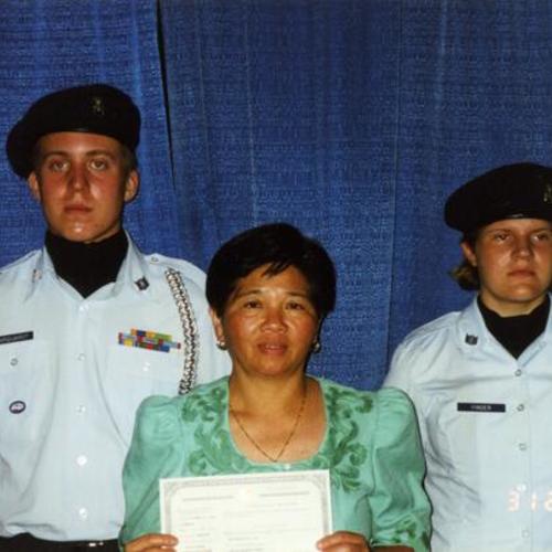 [Felisa with officers during her naturalization ceremony]
