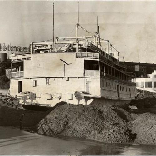 [Workers attempting to dig the riverboat "Fort Sutter" out of sand at Aquatic Park]