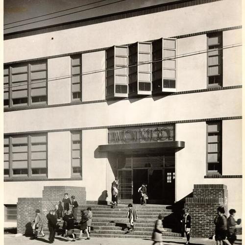 [Children standing near the entrance to Lawton School]