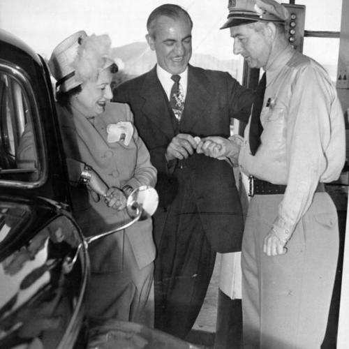 [Bridge District president paying tolltaker  for Mrs. F. Joseph Williams who drove the 50 millionth car to cross the Golden Gate Bridge]