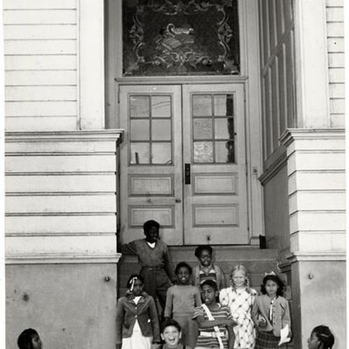 [Students at the entrance to Irving Scott School]