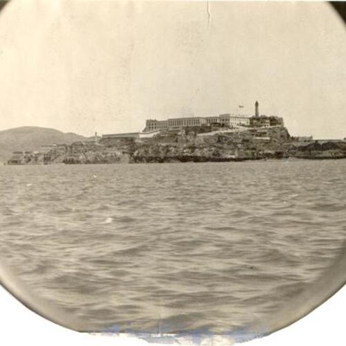 [View of Alcatraz Island and U. S. Disciplinary Barracks through porthole of a passing liner]