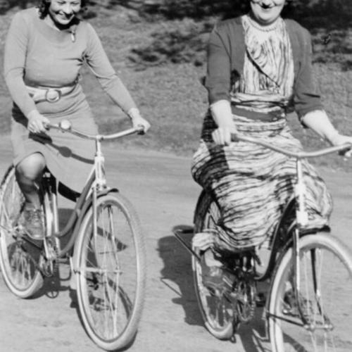 [Two women bicycling in Golden Gate Park]