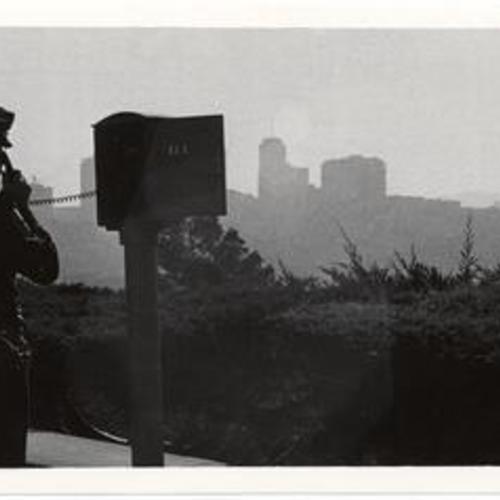 [Unidentified police officer making a call from a police call box]