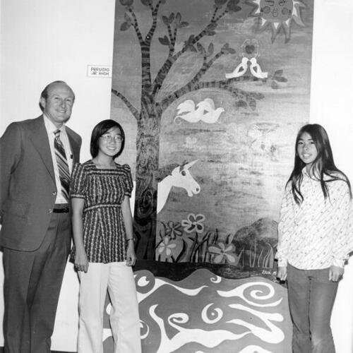 [Students and staff posing with a mural at Presidio Junior High School]