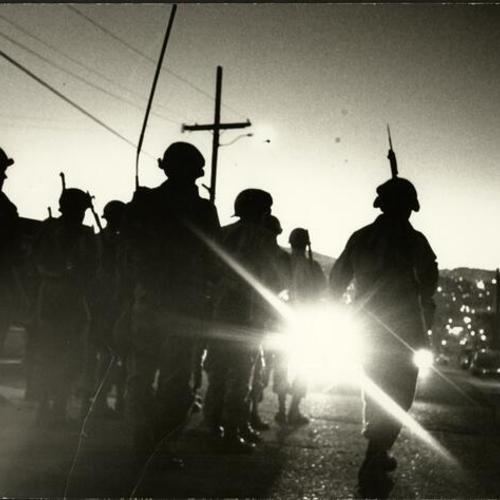 [Police officers in riot gear during the 1966 Bayview-Hunters Point riots]