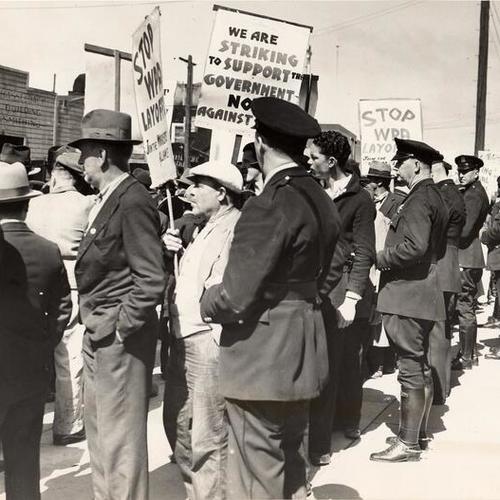  line of policemen holding back pickets during the 1937 WPA strike]