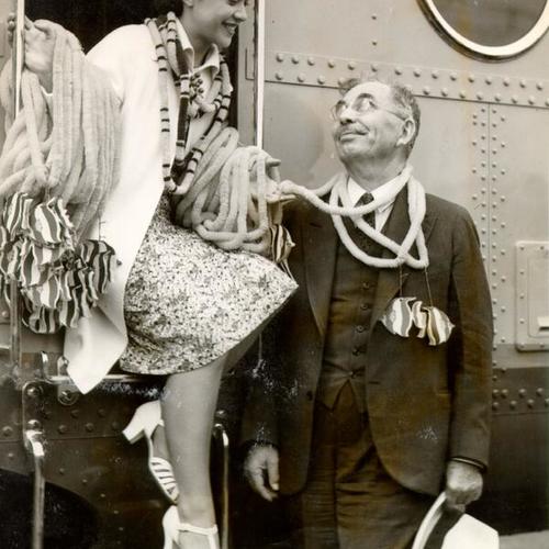 [Unidentified woman and man at a doorway of a car on the "City of San Francisco" streamlined train]