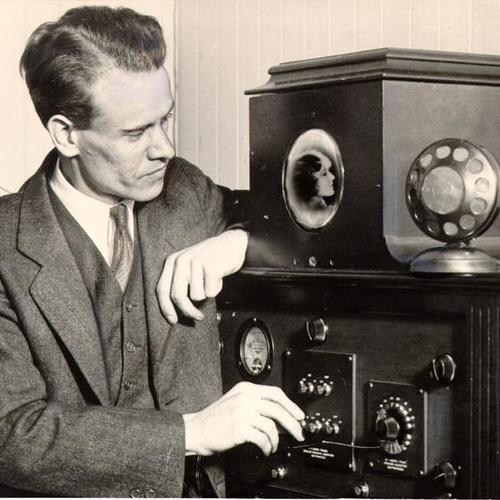 [Philo Farnsworth with a television set he invented]